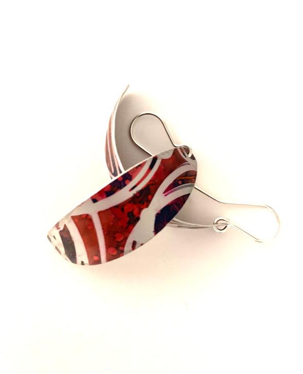 swirls of red/navy aluminium earrings part of the curved collection of jewellery by rachel-stowe