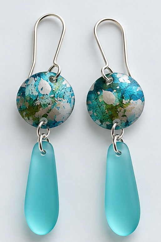 Handmade aqua sea glass and turquoise printed aluminium drop earrings by Rachel Stowe
This is probably my favourite name for the middle pair — the printed surface really does have that shoreline/drifting-water quality.